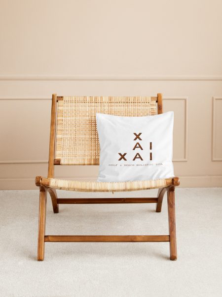 Wooden chair with woven backrest and printed cushion in spa-inspired interior - Xai-Xai hotel