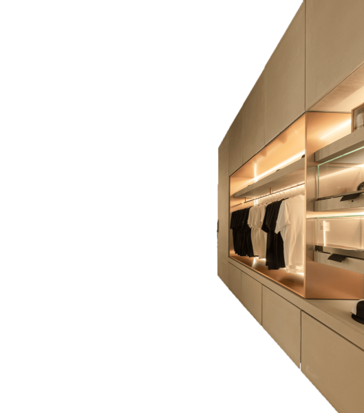 Modern built-in closet with warm lighting and organized clothing display - Piranha Tattoo Studios