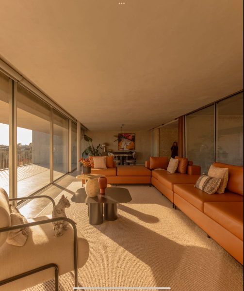 Modern and Cozy Living Room with Large Windows and Vibrant Artwork - Coffee/Side tables (things)