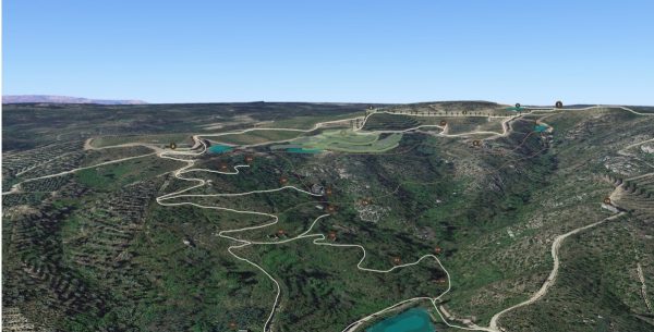 Aerial view of winding dirt roads, lakes, and lush vegetation in a mountainous landscape on a sunny day - QVVV Master Plan