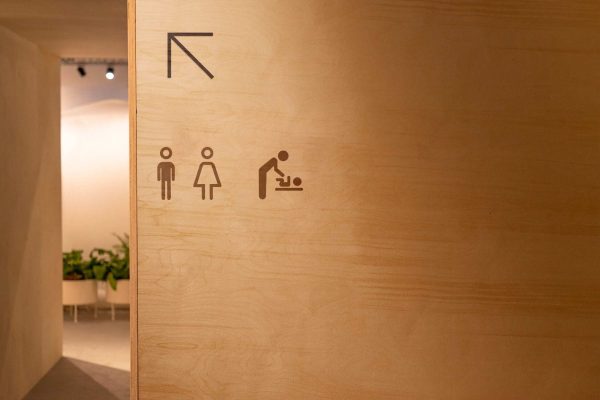 Wooden wall signage for restrooms and service direction - Xai-Xai hotel