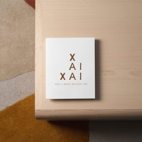 Elegant XAI Spa brand sign on light wood surface - Xai-Xai hotel